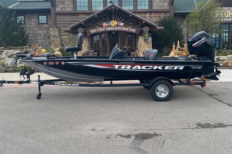 The Image of 2025 Tracker Pro Team 175 Crappie Edition boat parked outside a rustic building. - 0