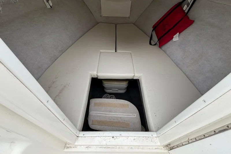 Slide: The Image of Interior cabin of 1999 Wellcraft 302 Scarab Sport boat, featuring seating and storage. - 9