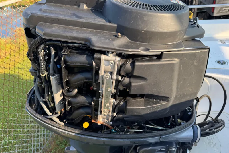 Slide: The Image of 2012 Carolina Skiff 238 DLV outboard motor, detailed view of engine components. - 11