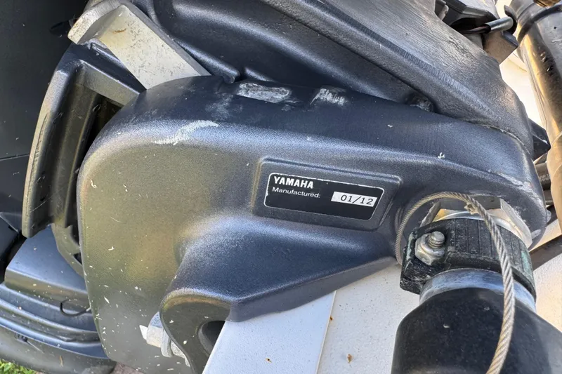 Slide: The Image of Close-up of a Yamaha engine part on a 2012 Carolina Skiff 238 DLV boat. - 14