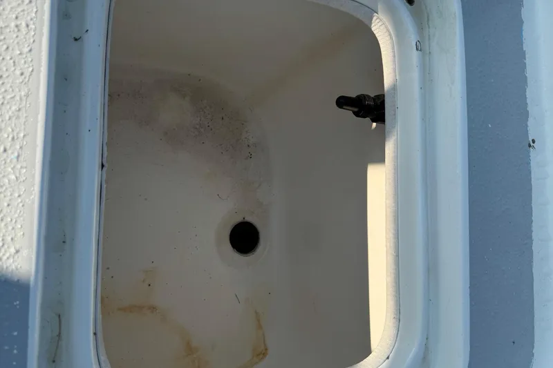 Slide: The Image of Open storage compartment on a 2012 Carolina Skiff 238 DLV boat. - 17