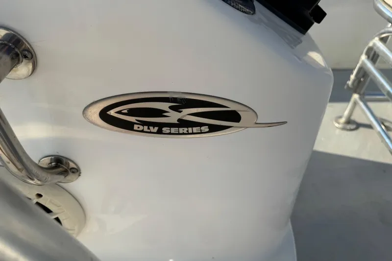 Slide: The Image of 2012 Carolina Skiff 238 DLV logo on white boat surface. - 22