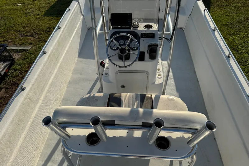 Slide: The Image of 2012 Carolina Skiff 238 DLV boat interior with steering console and rod holders. - 29