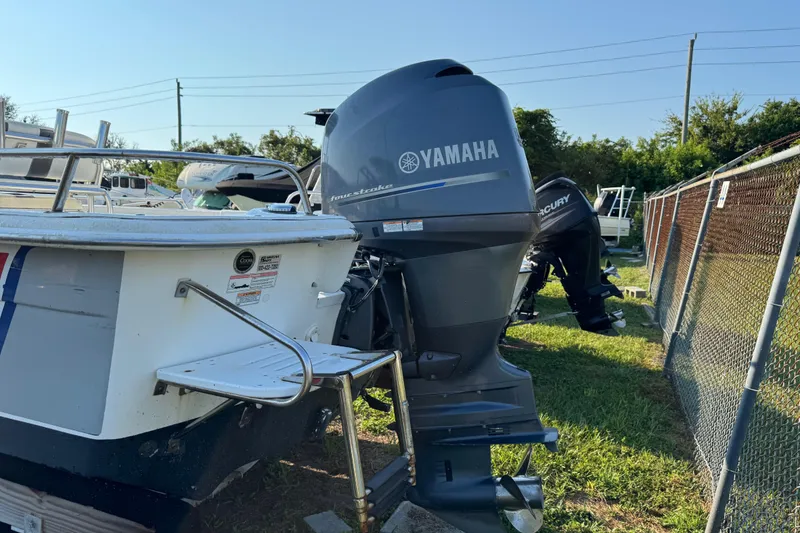 Slide: The Image of 2012 Carolina Skiff 238 DLV with Yamaha outboard motor, parked outdoors. - 3