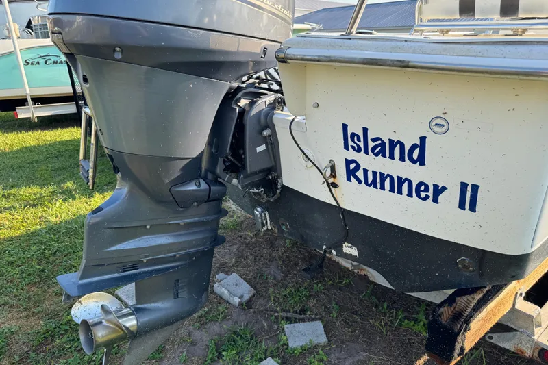 Slide: The Image of 2012 Carolina Skiff 238 DLV boat with "Island Runner II" name, outboard motor visible. - 4