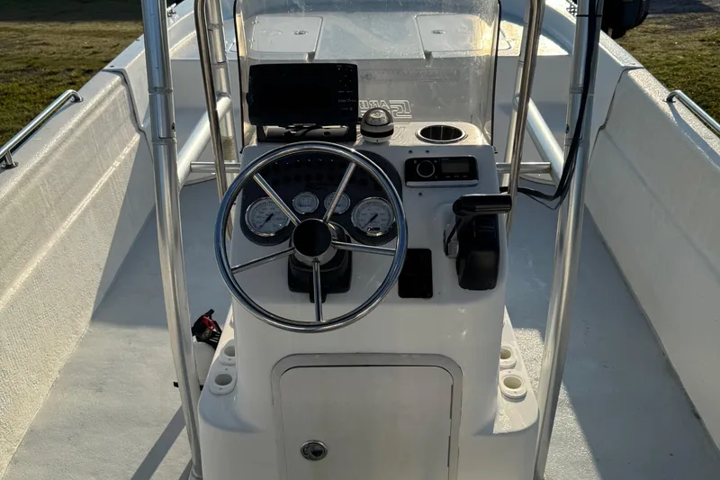 Slide: The Image of 2012 Carolina Skiff 238 DLV boat console with steering wheel and gauges. - 40