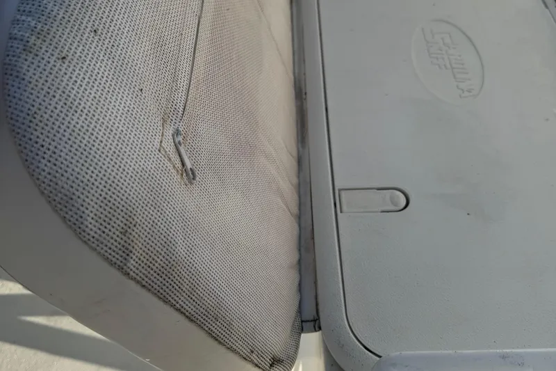 Slide: The Image of 2012 Carolina Skiff 238 DLV boat seat and storage compartment detail. - 41