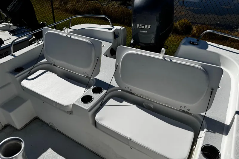 Slide: The Image of 2012 Carolina Skiff 238 DLV boat seating area with cup holders and Yamaha 150 engine. - 42