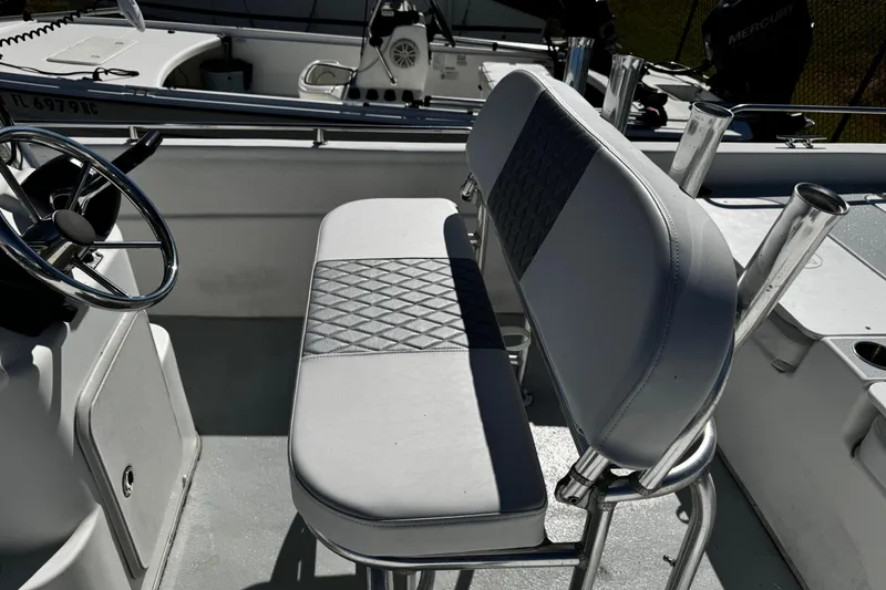 Slide: The Image of Interior of 2012 Carolina Skiff 238 DLV boat with steering wheel and seating. - 43