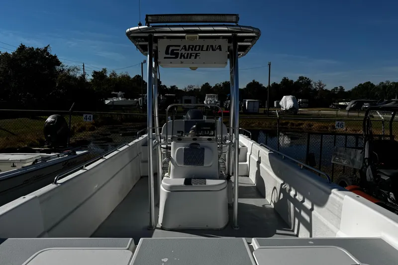 Slide: The Image of 2012 Carolina Skiff 238 DLV boat docked, featuring spacious interior and center console. - 44