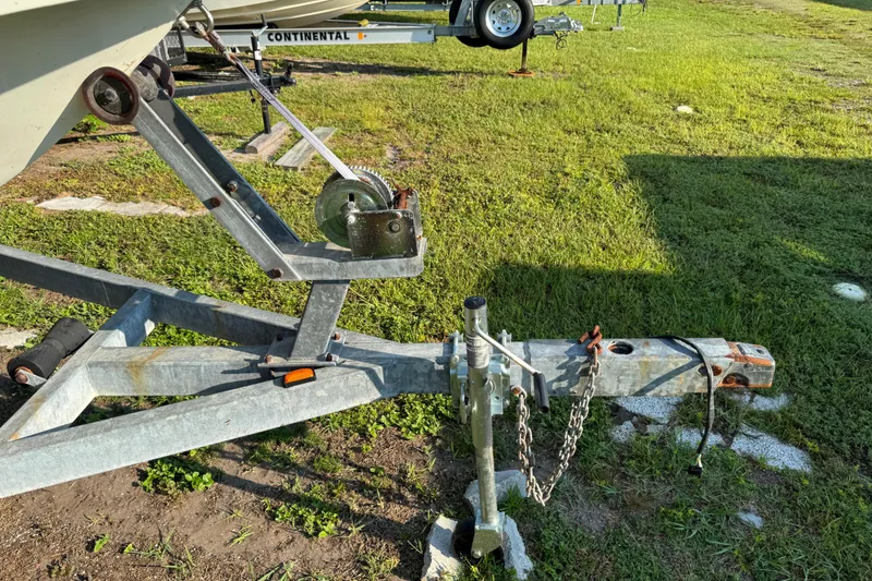 Slide: The Image of Trailer hitch and winch of a 2012 Carolina Skiff 238 DLV on grassy ground. - 7