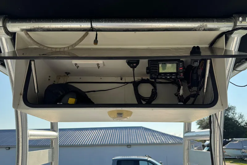 Slide: The Image of 2012 Carolina Skiff 238 DLV boat console with radio equipment and storage compartment. - 8
