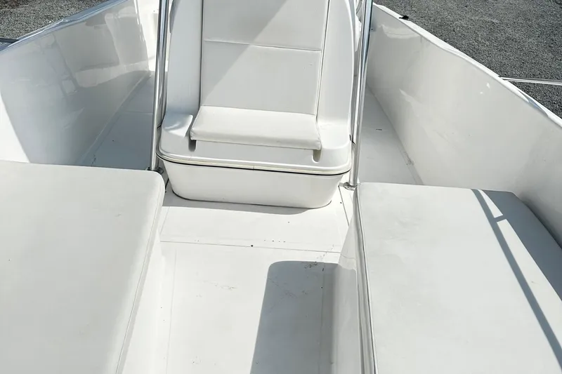 Slide: The Image of 1998 Angler 22 Center Console boat interior with white seating and clean deck. - 10