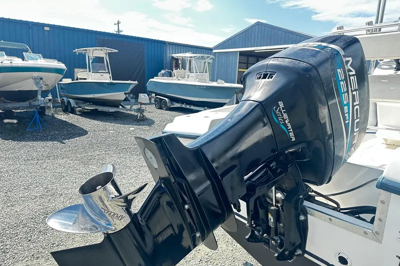 Slide: The Image of 1998 Angler 22 Center Console with Mercury 225 EFI outboard motor in a boatyard. - 13