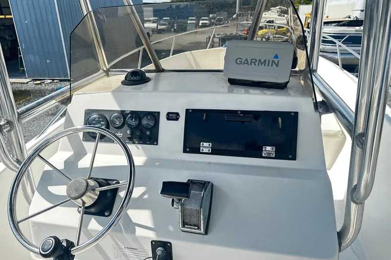 Slide: The Image of 1998 Angler 22 Center Console boat dashboard with Garmin GPS and steering wheel. - 4
