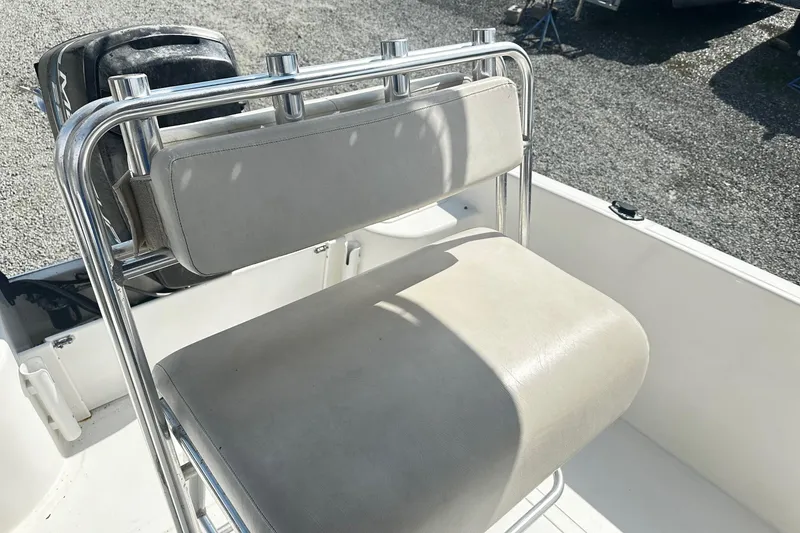 Slide: The Image of 1998 Angler 22 Center Console boat seat with stainless steel frame in sunlight. - 9