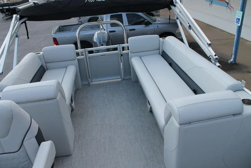 Slide: The Image of 2026 Avalon VLS QUAD LOUNGER 21 boat interior with steering wheel and cup holders. - 11