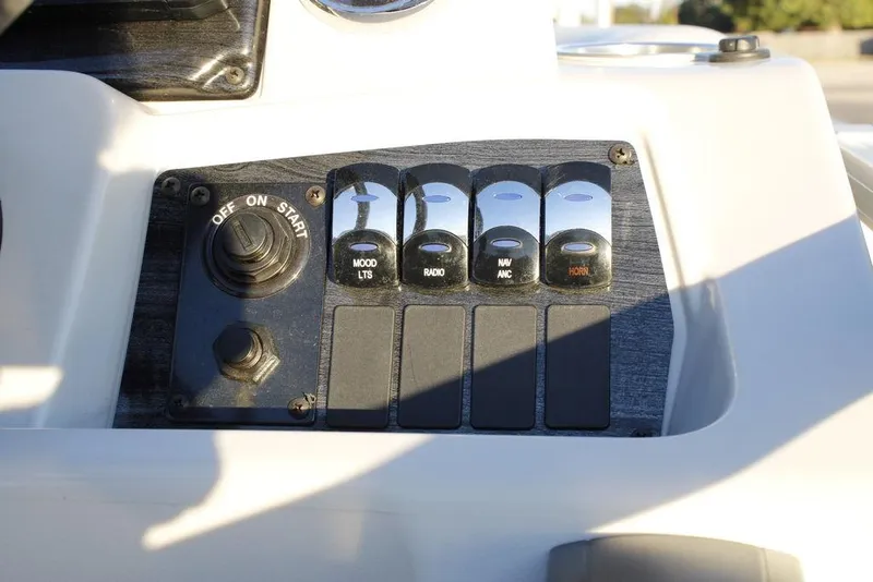 Slide: The Image of Control panel of 2026 Avalon VLS QUAD LOUNGER 21 boat with switches and ignition. - 23