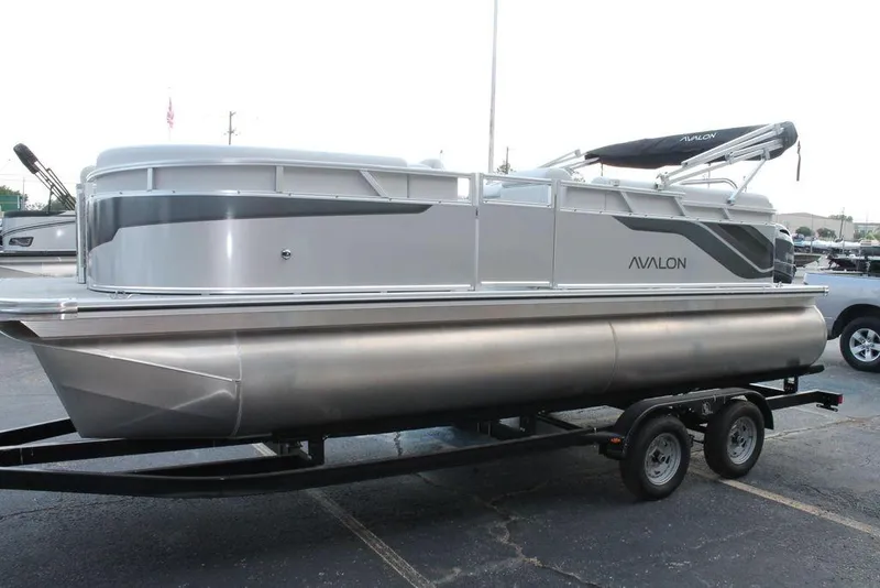 Slide: The Image of 2026 Avalon VLS QUAD LOUNGER 21 pontoon boat on trailer in parking lot. - 4