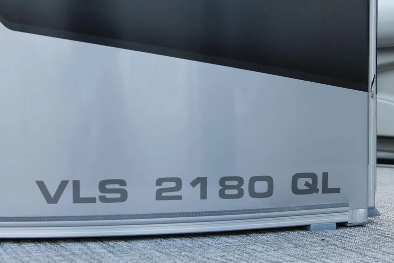 Slide: The Image of 2026 Avalon VLS QUAD LOUNGER 21 pontoon boat on trailer in parking lot. - 7