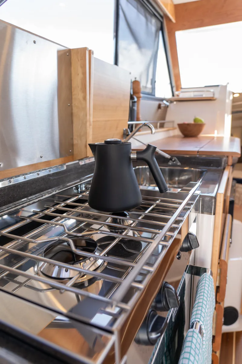 Slide: The Image of Modern kitchen in 2025 Cutwater C-32 Coupe yacht with stove and kettle. - 6