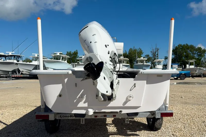 Slide: The Image of 2026 Coastal Skiff 171 boat on trailer, rear view with outboard motor. - 4