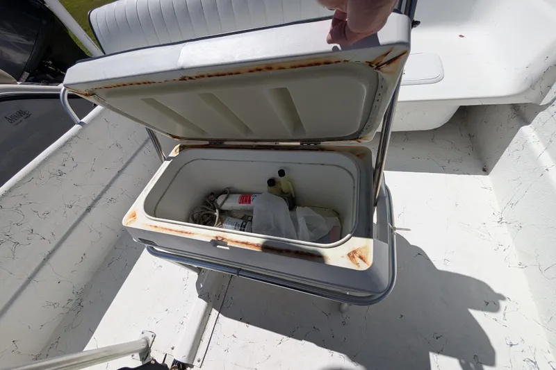Slide: The Image of Open storage compartment on 2006 Carolina Skiff 2180 DLX boat, showing interior contents. - 10