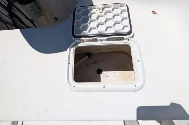 Slide: The Image of Open storage compartment on a 2006 Carolina Skiff 2180 DLX boat deck. - 13