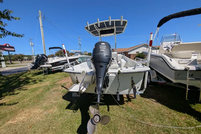 Slide: The Image of 2006 Carolina Skiff 2180 DLX boat with outboard motor on display outdoors. - 3