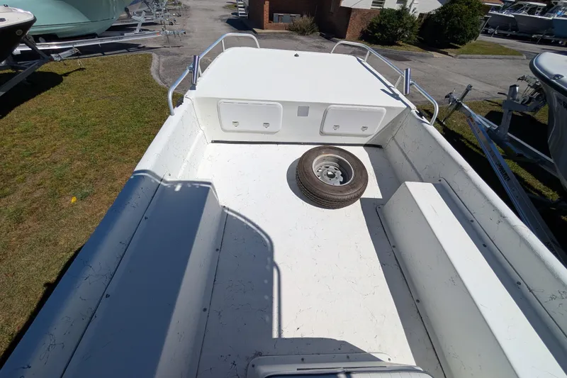 Slide: The Image of 2006 Carolina Skiff 2180 DLX boat interior with spare tire on deck. - 4