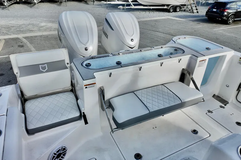 Slide: The Image of 2026 Sea Fox 328 Commander boat interior with seating and dual outboard engines. - 13