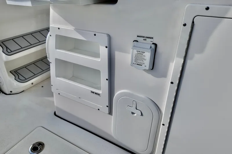 Slide: The Image of 2026 Sea Fox 328 Commander boat interior with storage compartments and inverter charger. - 16