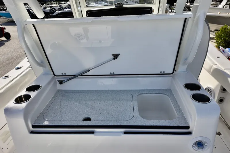 Slide: The Image of 2026 Sea Fox 328 Commander boat with open storage compartment and cup holders. - 23