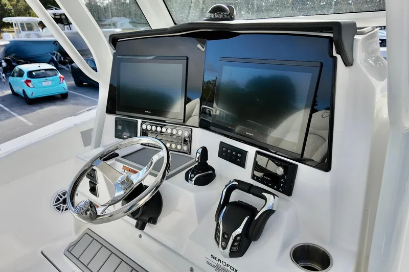 Slide: The Image of Helm of 2026 Sea Fox 328 Commander with dual Garmin displays and modern controls. - 24