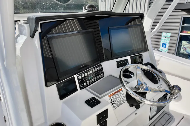 Slide: The Image of 2026 Sea Fox 328 Commander helm with dual screens and modern controls. - 26