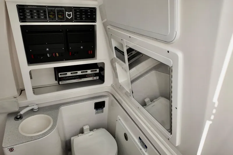 Slide: The Image of 2026 Sea Fox 328 Commander boat interior with sink, toilet, and control panels. - 3