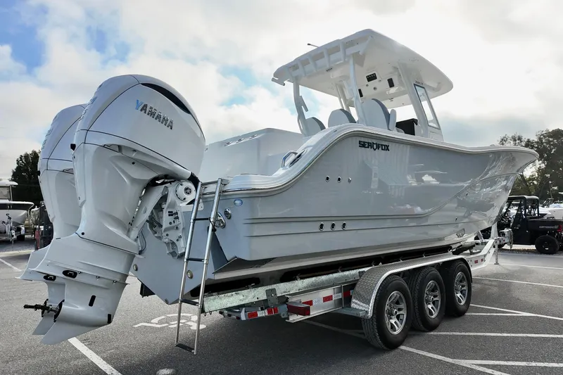 Slide: The Image of 2026 Sea Fox 328 Commander boat on trailer with Yamaha engines, parked outdoors. - 36