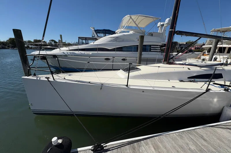 Slide: The Image of 2014 J Boats J/111 sailboat docked beside a larger yacht on a sunny day. - 12
