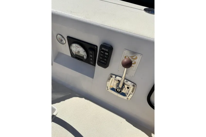 Slide: The Image of Control panel of a 2014 J Boats J/111 sailboat, featuring gauges and throttle lever. - 13