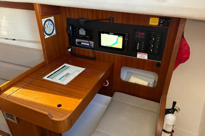 Slide: The Image of Navigation station of 2014 J Boats J/111 with electronic equipment and wooden desk. - 17