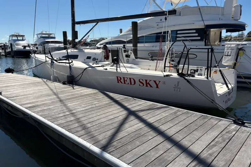 Slide: The Image of 2014 J Boats J/111 "Red Sky" sailboat docked at marina, sunny day. - 2