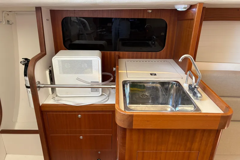Slide: The Image of 2014 J Boats J/111 interior galley with sink, faucet, and storage cabinets. - 20