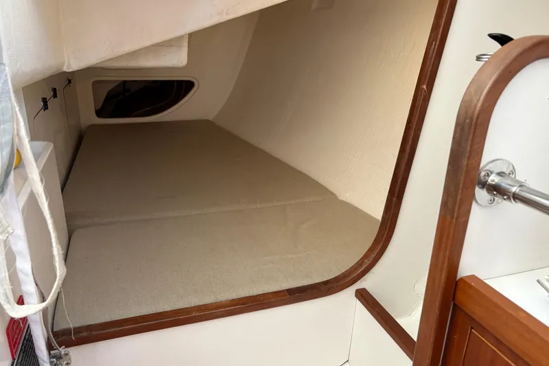 Slide: The Image of 2014 J Boats J/111 interior cabin with beige cushions and wooden trim. - 21