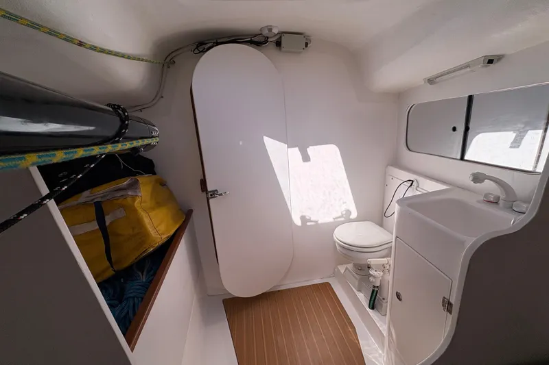 Slide: The Image of Interior of 2014 J Boats J/111 sailboat, featuring compact bathroom with toilet and sink. - 24