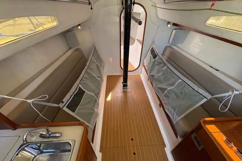 Slide: The Image of Interior of 2014 J Boats J/111 sailboat, featuring sleek design and wooden flooring. - 26