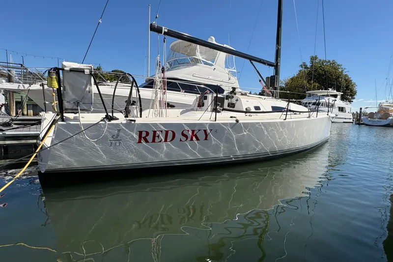 Slide: The Image of 2014 J Boats J/111 sailboat "Red Sky" docked in a marina under clear blue skies. - 3