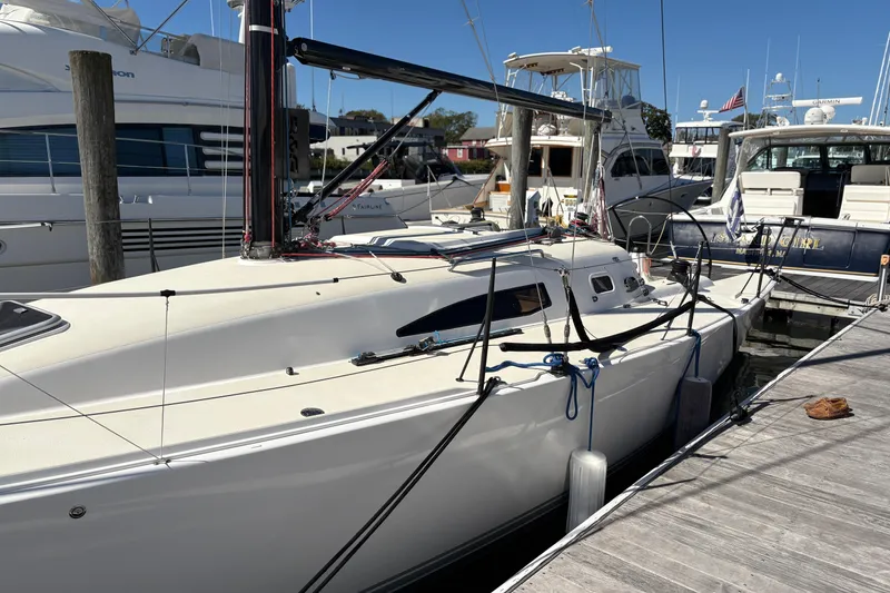 Slide: The Image of 2014 J Boats J/111 sailboat docked at marina, surrounded by other yachts. - 6