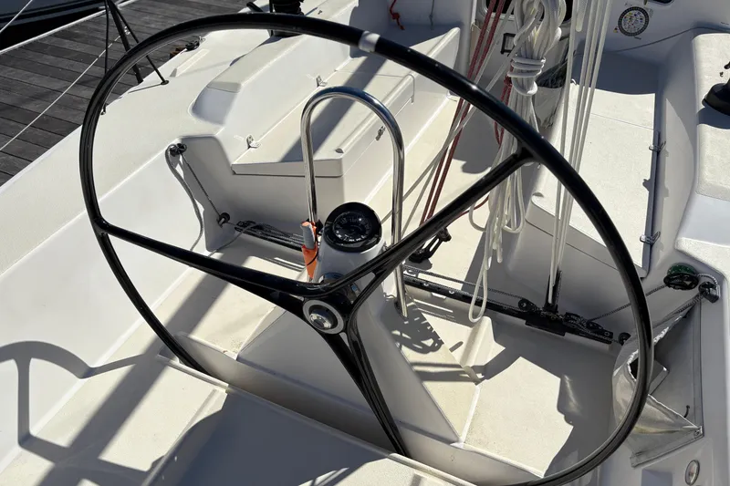 Slide: The Image of Steering wheel of 2014 J Boats J/111 sailboat, featuring ropes and navigation instruments. - 8