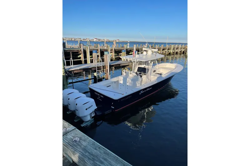 Slide: The Image of 2018 Regulator 34SS boat docked with triple Yamaha engines, clear blue sky. - 3