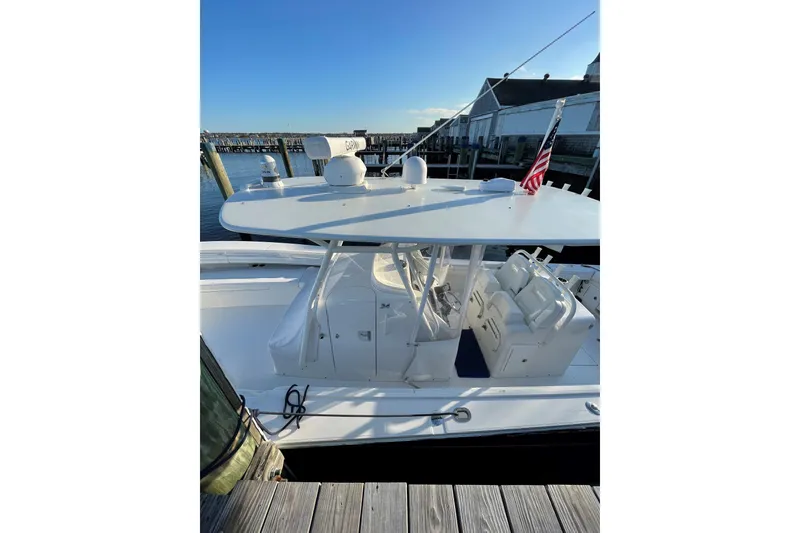 Slide: The Image of 2018 Regulator 34SS boat docked, featuring a sleek design and American flag. - 6